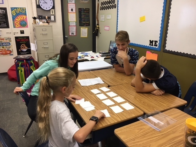 A group of 7th grade students playing a Memory game to test knowledge of nouns.